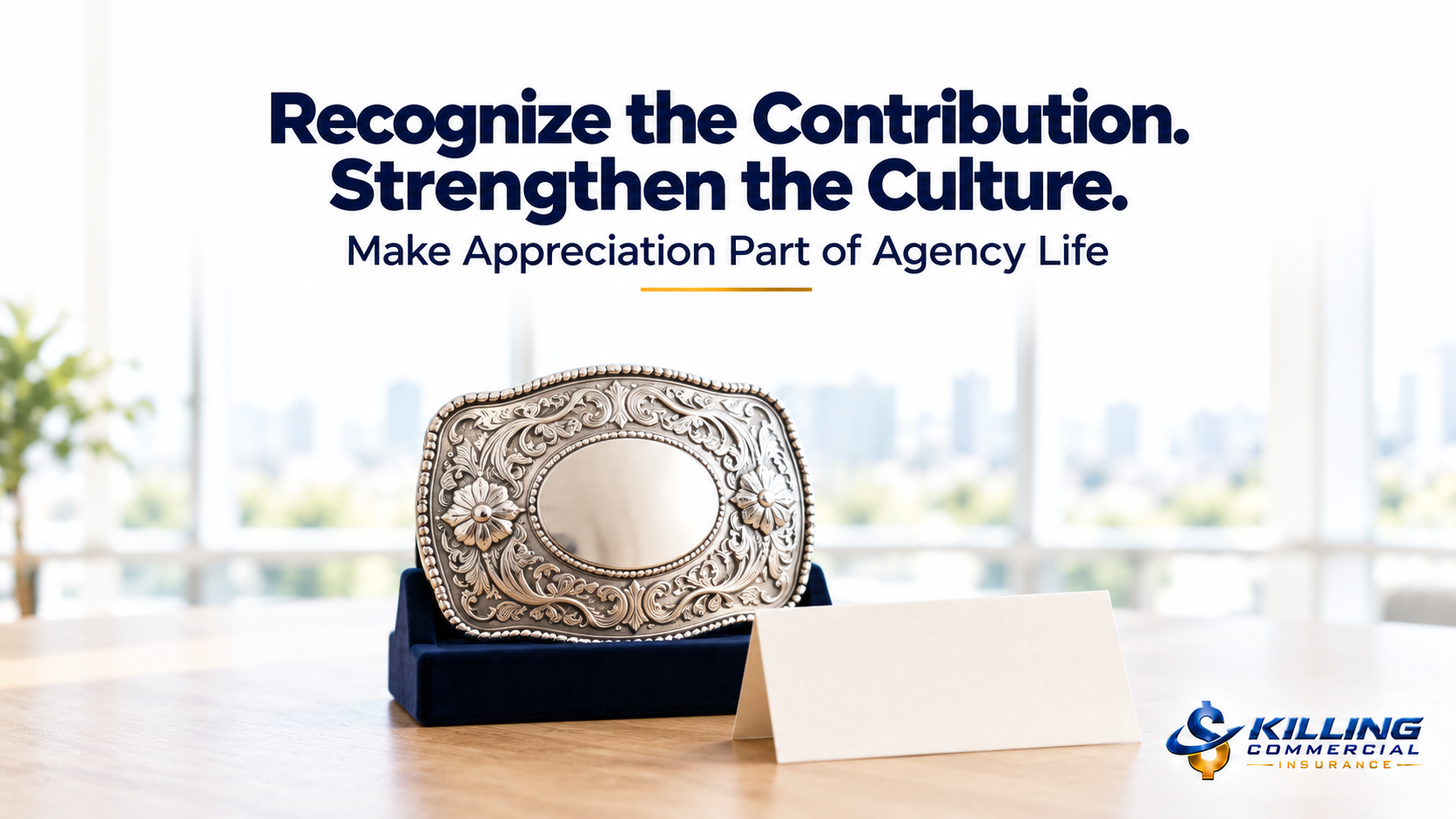 Silver award belt buckle and appreciation card illustrating meaningful recognition in an insurance agency’s culture.